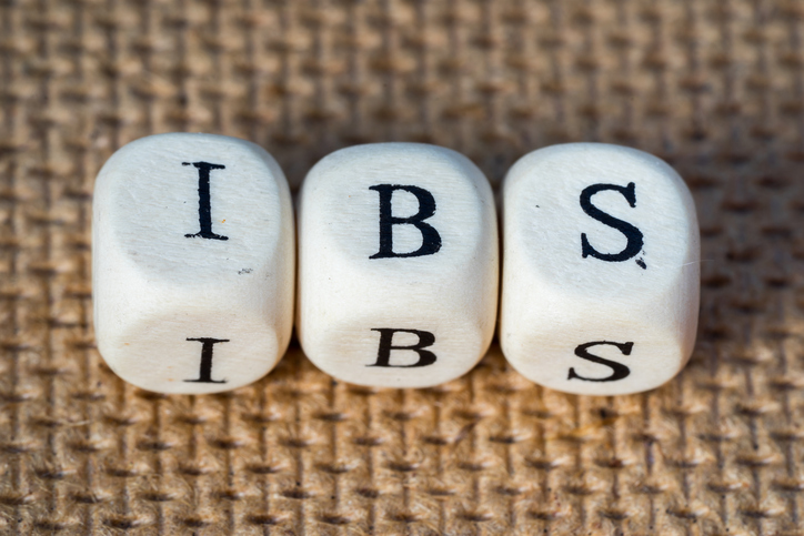 IBS - three dice with the inscription I - B - S on a brown background