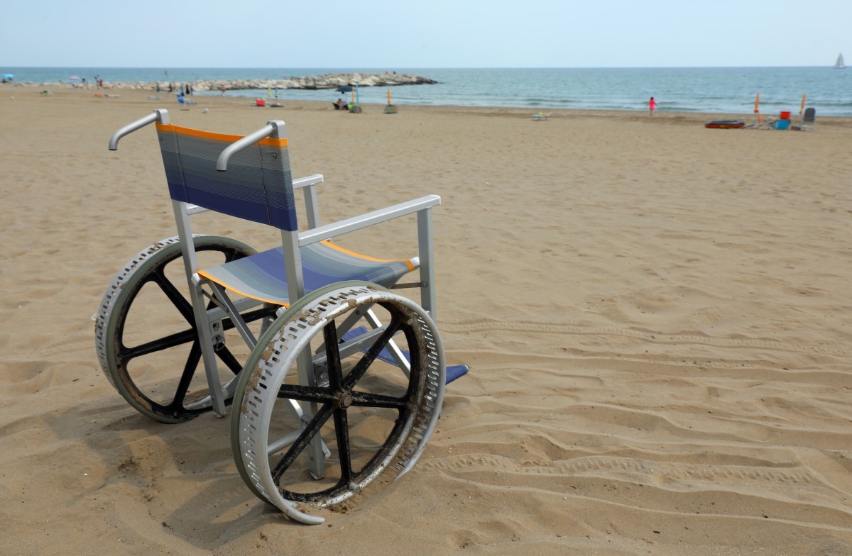 Empty wheelchair on the beach