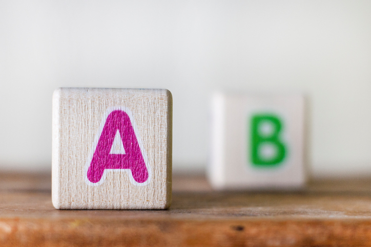 wooden cubes with pink letter A and green letter B