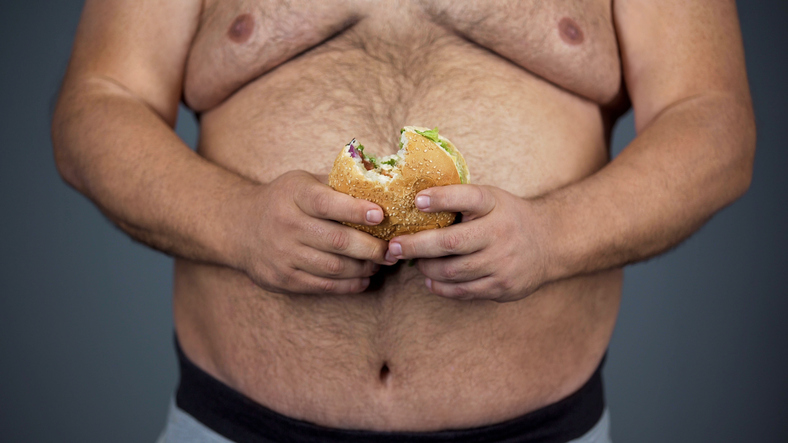 Man, a big belly and a hamburger