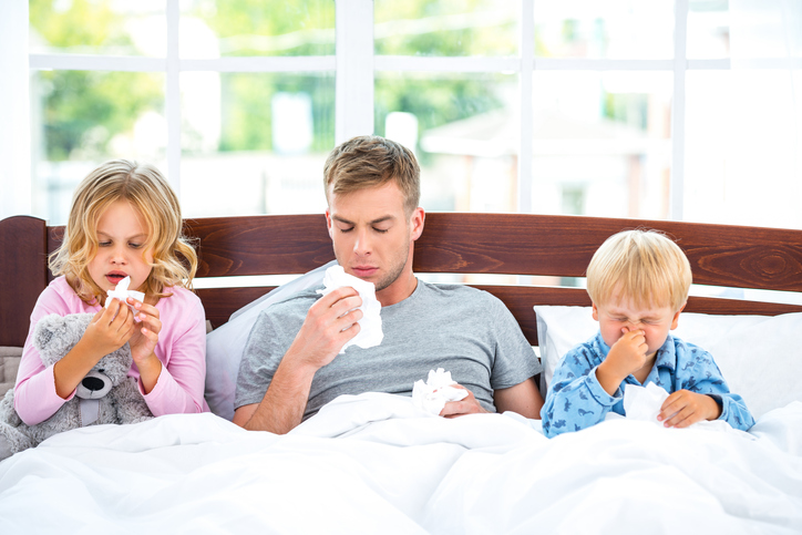 Infectious rhinitis is highly contagious, family in bed, father and children