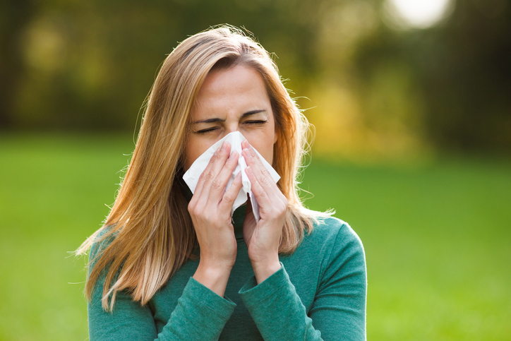 Non-infectious, allergic rhinitis, woman has a cold, sneezes