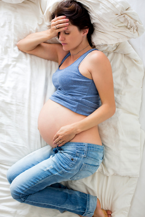 Pregnancy and insomnia, woman lying on the bed