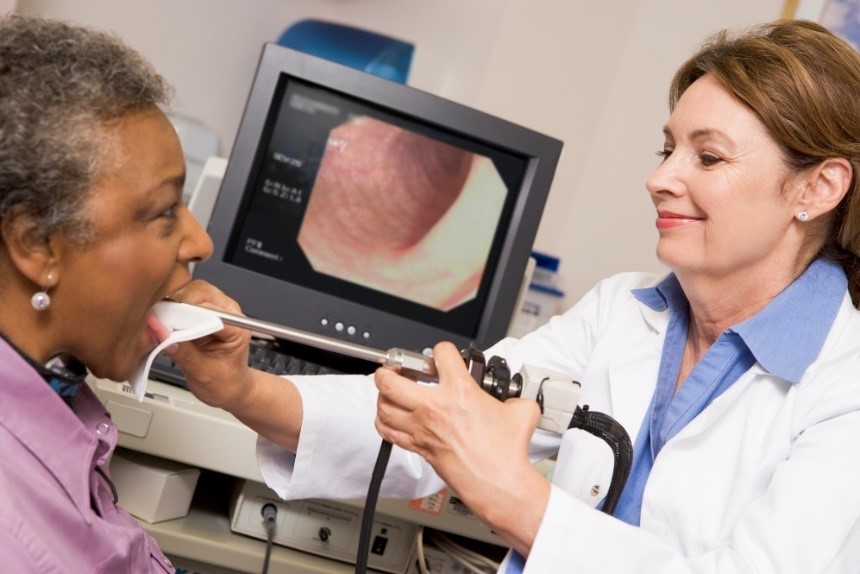Diagnostic imaging - Laryngoscopy, woman and doctor with endoscope, camera and examination