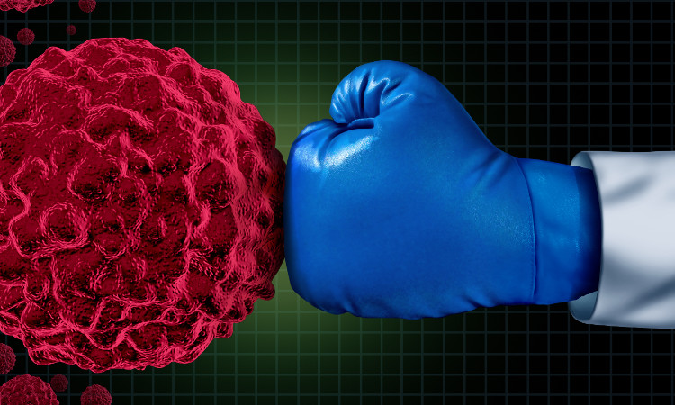 a punch with a blue boxing glove to a tumor cell