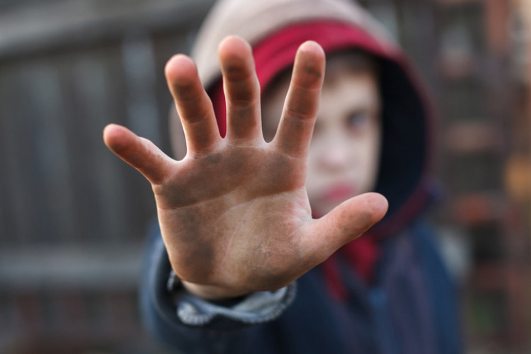 Child with dirty hands, hand pointing in front of him