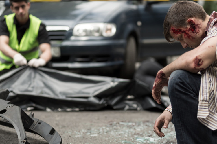 man with bloody head after car accident