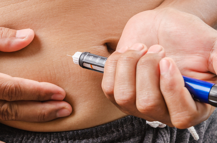 injection of insulin under the skin of the abdomen with an insulin pen