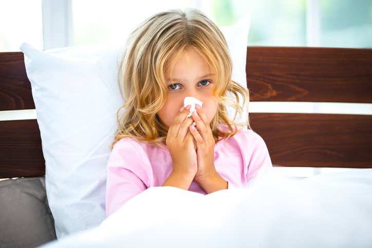 Girl has flu, cold, lying in bed