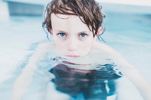 the boy is in the pool, swimming is a suitable physical activity