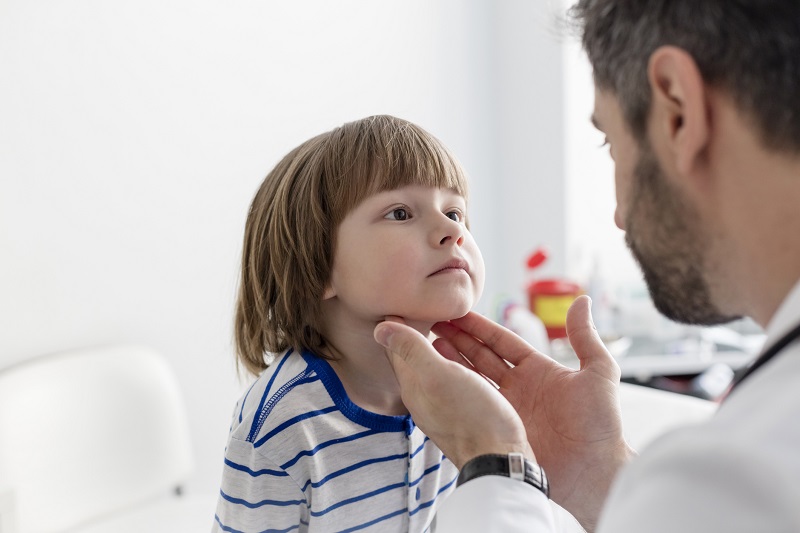 Medical examination of the tonsils in a child