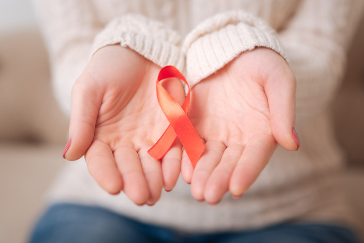 red ribbon in the woman's hands