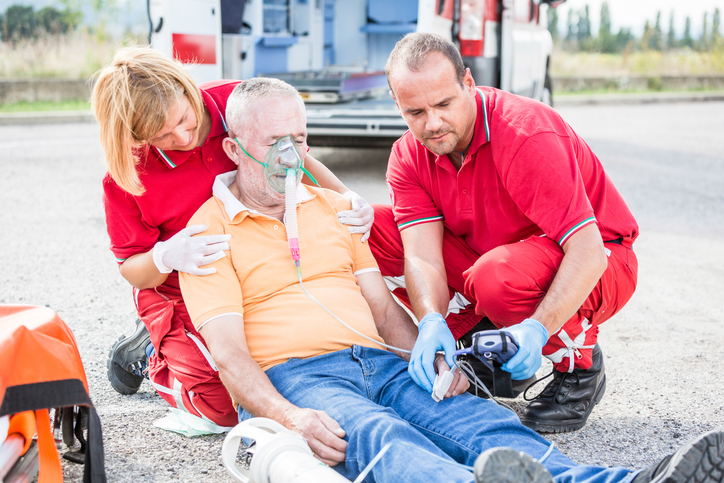 paramedics next to a collapsed patient