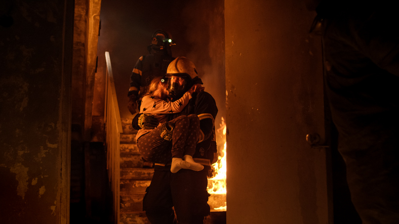 fire in the house, firefighters carry out the child in their arms