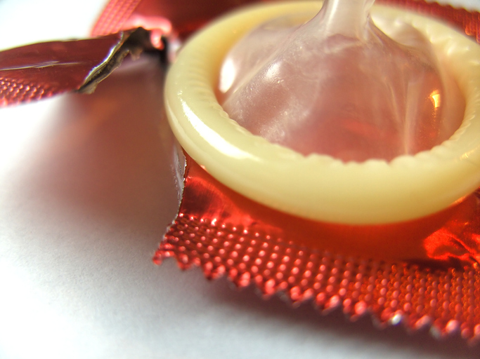 Condom removed from packaging, ruptured packaging, as prevention of gonorrhea and other STDs, barrier contraception