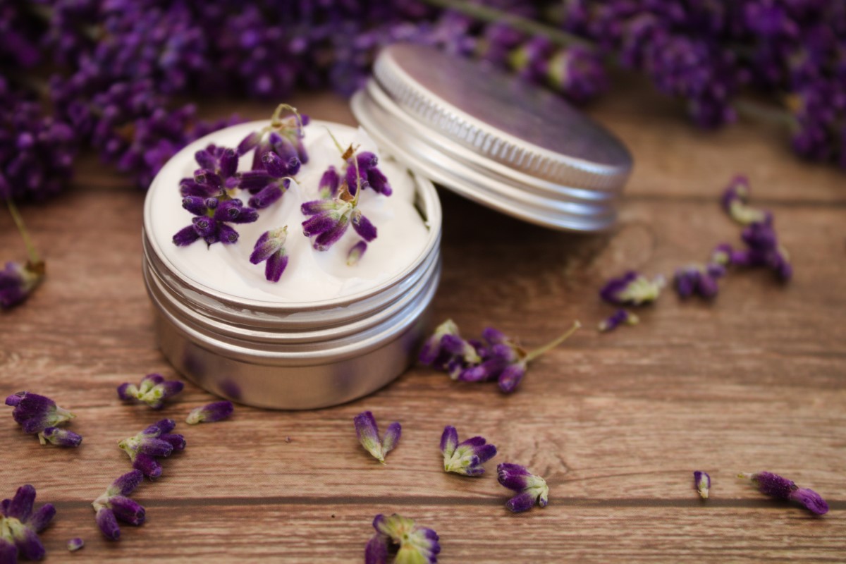 Lavender cream laid on a wooden table as migraine prophylaxis