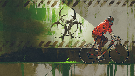 a man on a bicycle with a gas mask passing through a biohazard zone