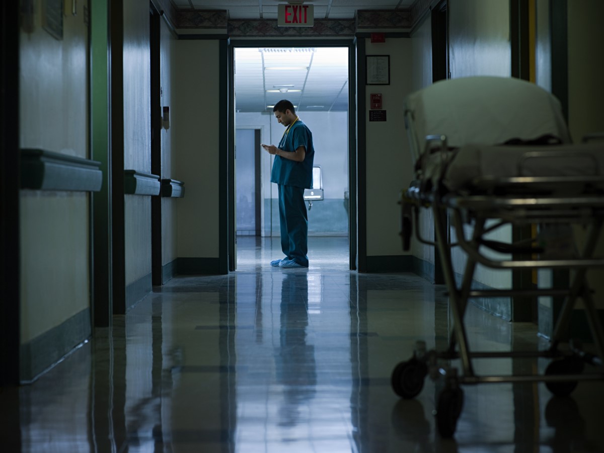 Night work and its effect on circadian rhythm disorders - An example is the night work of health care workers - a doctor standing in the corridor of a hospital.