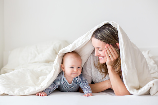 Laughing child with mother under the palanquin