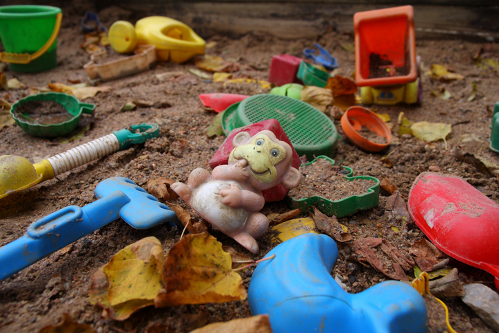 Old toys in a polluted sandbox