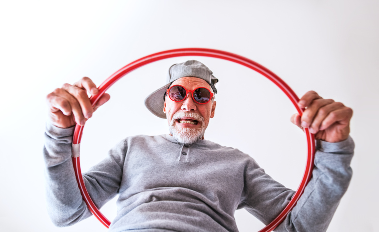an older man in a cap with a circle
