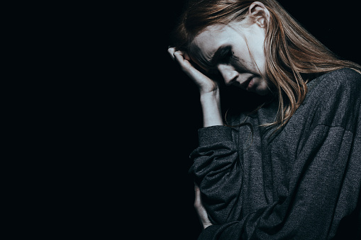 depressed woman, crying and holding her head