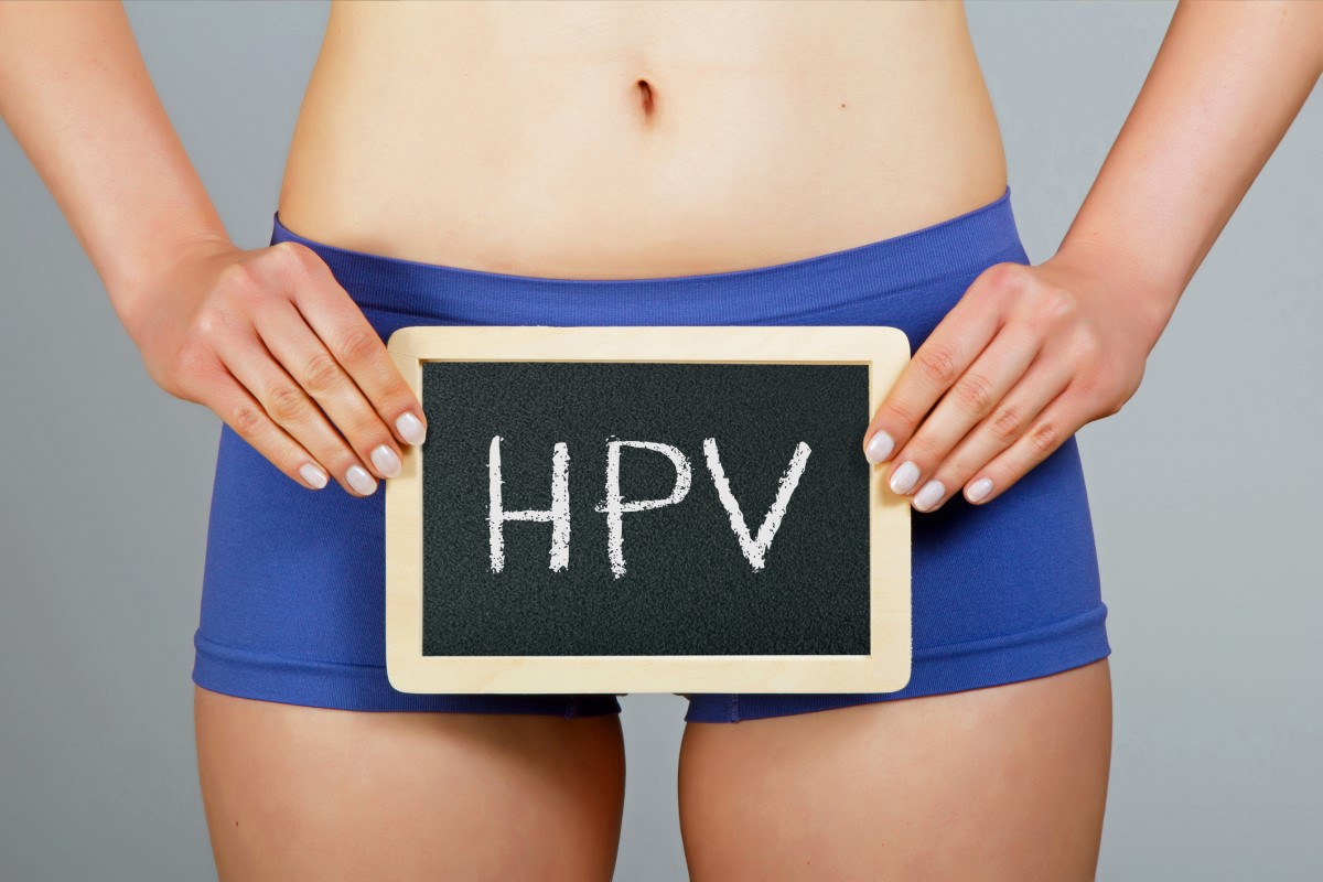 Woman holding a sign that says HPV