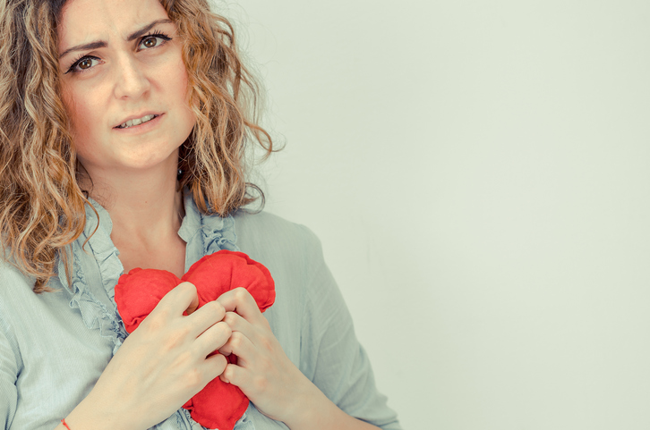 woman holding a red plush heart