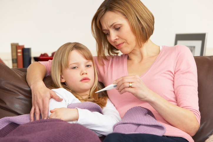 Concerned mother takes her daughter's temperature