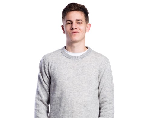 Teenage boy, brown hair, wearing a pale sweater