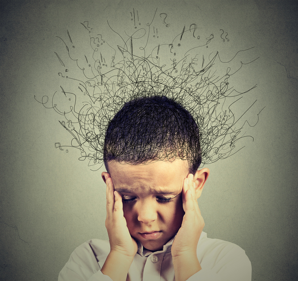 Child has a mood disorder for ADHD, holds his head with his hands on his temples, chaotic thoughts from his head, a jumble of questions, thoughts, can't concentrate