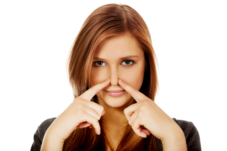 girl with fingers on her nose. stuffy nose