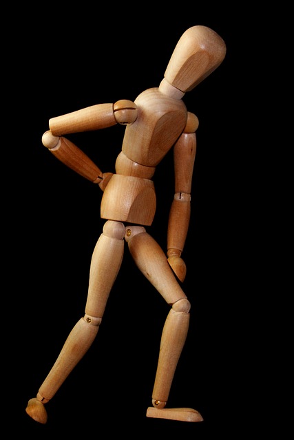 Wooden dummy with lower back pain.