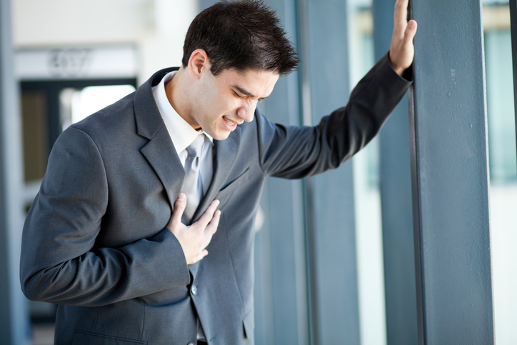 A young man, a businessman is in trouble, chest pains, maybe he has a heart attack or is overworked