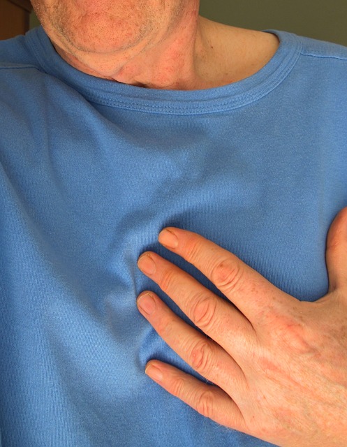 man holding his chest with his hand, chest pain like a heart attack