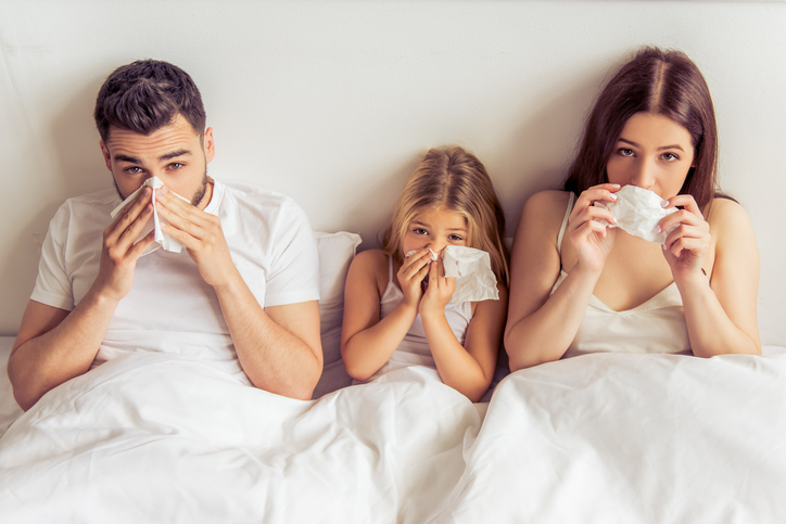 The family, i.e. father, mother and daughter are lying in bed, their noses are full, they have a cold, because of an illness, for example, the flu