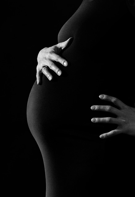 Pregnant woman, cutout, chest, belly, arms, black dress