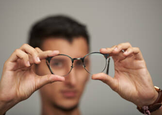 Myopia: The onset of myopia + how does impaired distance vision appear?